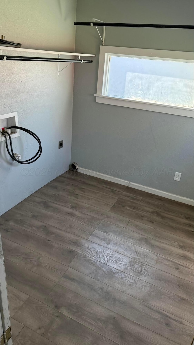 laundry area featuring hookup for an electric dryer, washer hookup, laundry area, baseboards, and wood finished floors