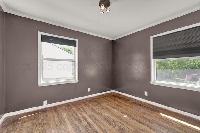 unfurnished room featuring wood finished floors, baseboards, and ornamental molding