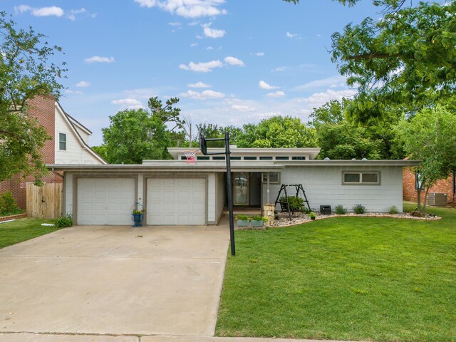 123 Bellaire Ave, Dumas, TX 79029 - mid-century inspired home with an attached garage, concrete driveway, and cooling unit