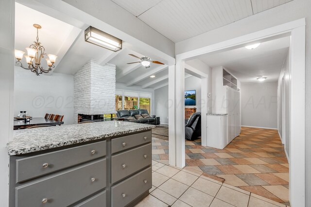 123 Bellaire Ave, Dumas, TX 79029 - kitchen featuring gray cabinetry, ceiling fan, a chandelier, and decorative light fixtures