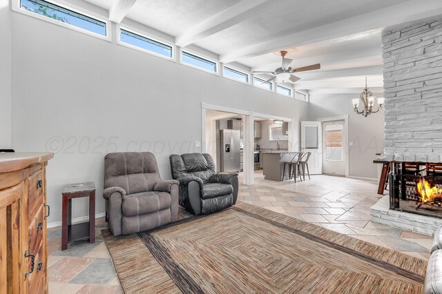 123 Bellaire Ave, Dumas, TX 79029 - living room featuring ceiling fan, stone tile flooring, a towering ceiling, beamed ceiling, and a chandelier