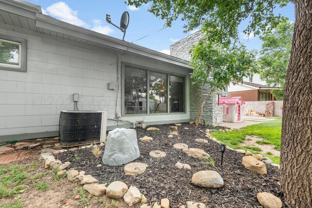 123 Bellaire Ave, Dumas, TX 79029 - exterior view of a satellite dish and central AC