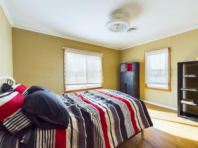 bedroom featuring hardwood / wood-style floors and crown molding