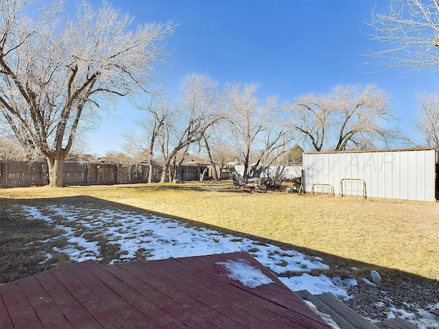 snow covered deck with a lawn