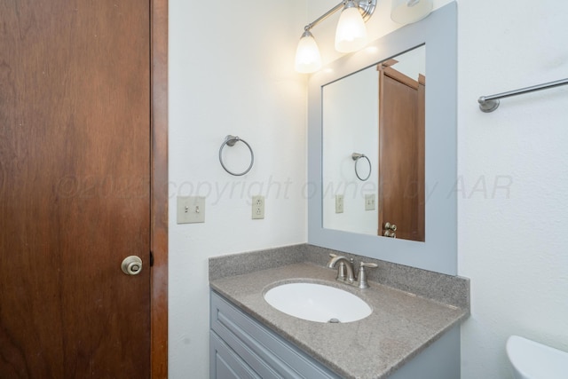 bathroom featuring toilet and vanity