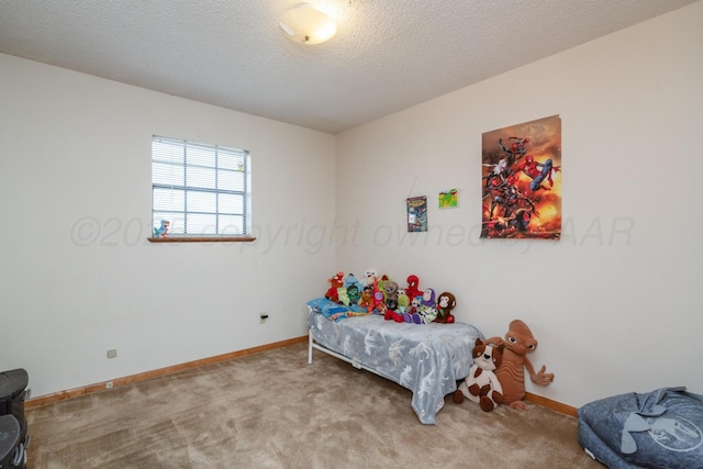 carpeted bedroom with baseboards and a textured ceiling