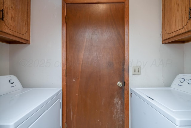 washroom with washing machine and clothes dryer and cabinet space