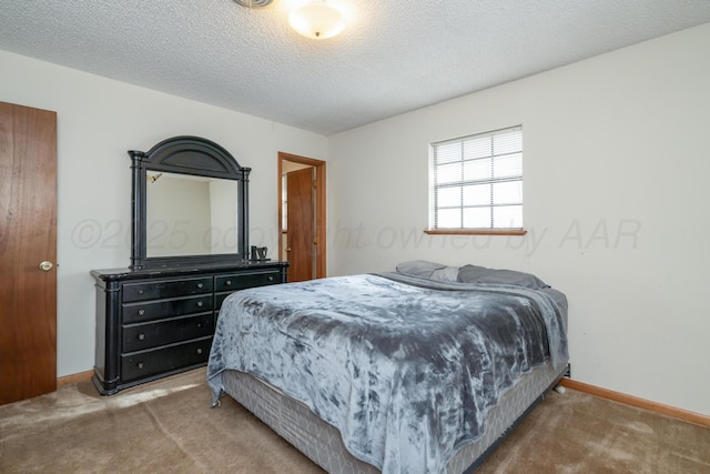 bedroom featuring baseboards, carpet floors, and a textured ceiling