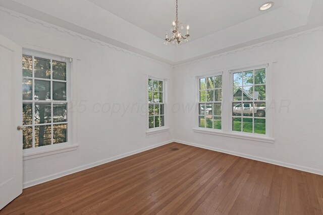 2214 S Ong St, Amarillo, TX 79109 - empty room with baseboards, wood-type flooring, and a chandelier