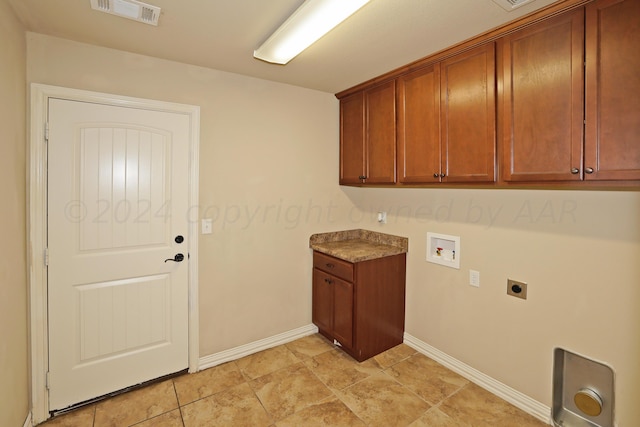 9315 Gaston Ave, Amarillo, TX 79119 - clothes washing area featuring cabinets, hookup for a washing machine, and electric dryer hookup