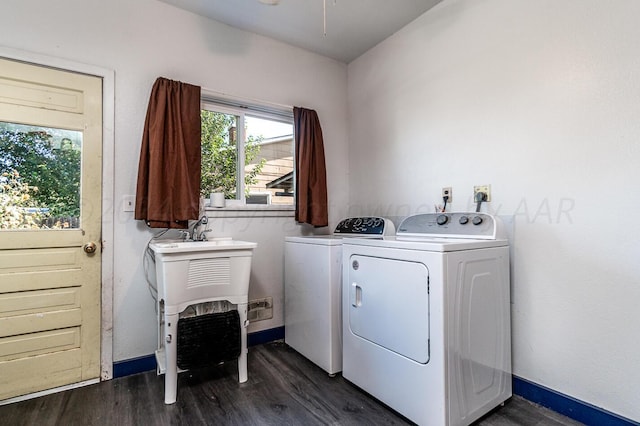 laundry area featuring washing machine and clothes dryer and dark hardwood / wood-style flooring