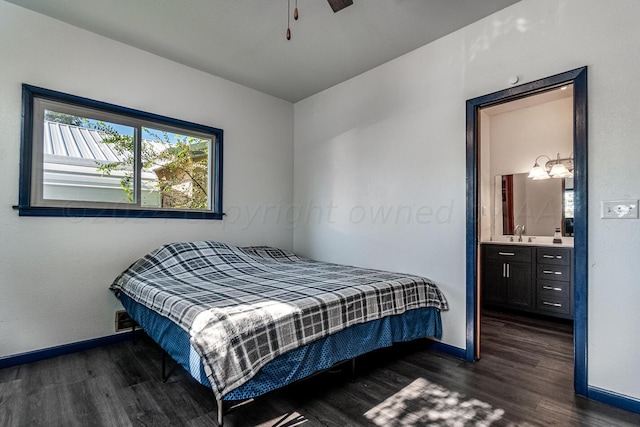 bedroom with dark hardwood / wood-style floors, ceiling fan, sink, and connected bathroom