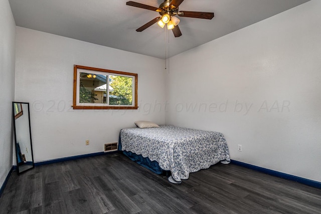 bedroom with ceiling fan and dark hardwood / wood-style floors