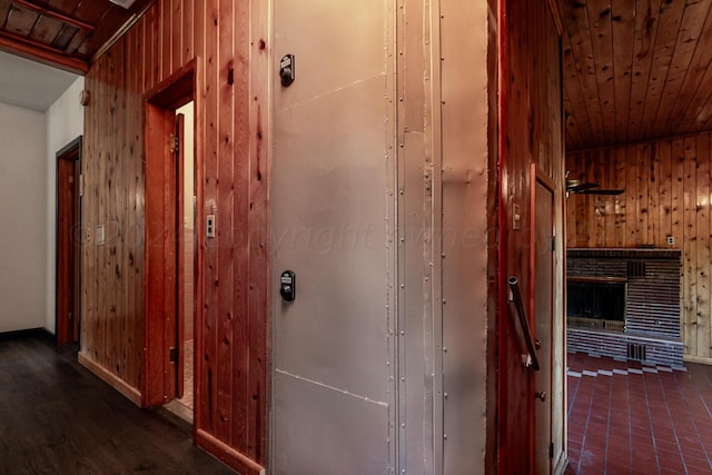 hall featuring wood walls and wooden ceiling