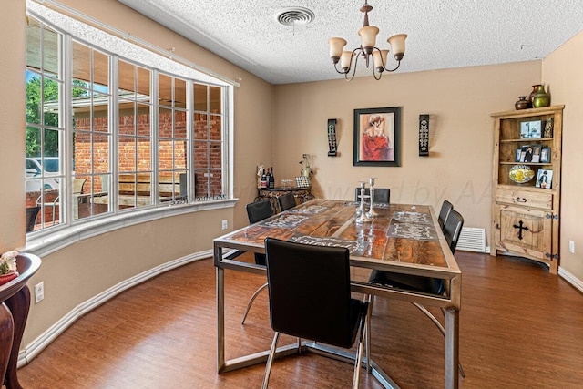 5216 Westway Trl, Amarillo, TX 79109 - dining space featuring wood finished floors, a chandelier, and a textured ceiling