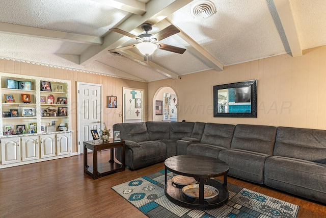 5216 Westway Trl, Amarillo, TX 79109 - living room with dark wood-type flooring, ceiling fan, arched walkways, a textured ceiling, and wooden walls