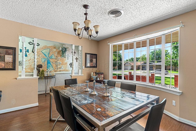 5216 Westway Trl, Amarillo, TX 79109 - dining room with a chandelier, wood finished floors, and a textured ceiling
