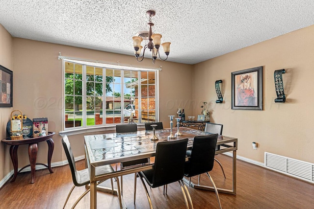5216 Westway Trl, Amarillo, TX 79109 - dining space with a chandelier, a textured ceiling, and wood finished floors