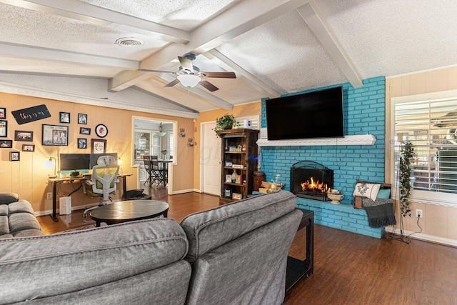 5216 Westway Trl, Amarillo, TX 79109 - living area featuring wood finished floors, a textured ceiling, a ceiling fan, a fireplace, and wooden walls