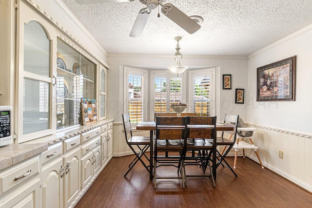 5216 Westway Trl, Amarillo, TX 79109 - dining space featuring a ceiling fan, dark wood finished floors, a textured ceiling, and ornamental molding