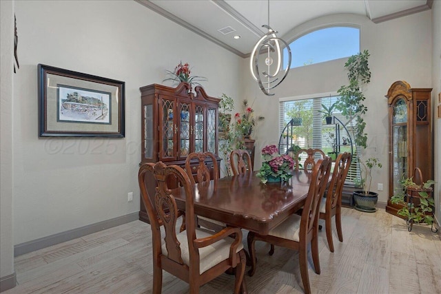 8205 S Liberty Cir, Amarillo, TX 79119 - dining area featuring crown molding, a high ceiling, and light wood-style floors