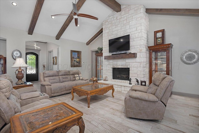 8205 S Liberty Cir, Amarillo, TX 79119 - living room featuring a ceiling fan, light wood-style floors, a stone fireplace, arched walkways, and recessed lighting