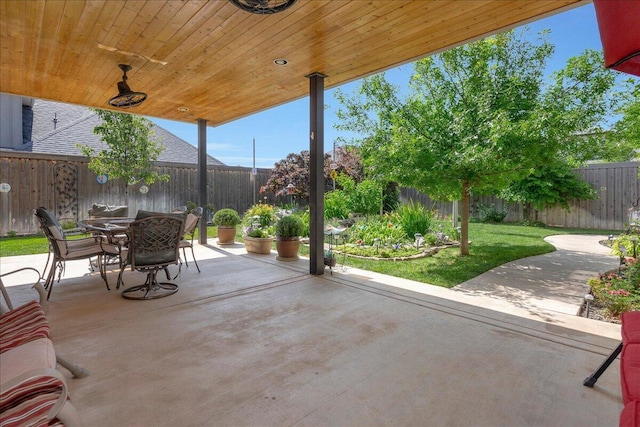 8205 S Liberty Cir, Amarillo, TX 79119 - fenced backyard with outdoor dining space and a patio