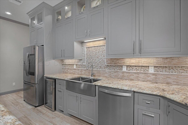 8205 S Liberty Cir, Amarillo, TX 79119 - kitchen featuring stainless steel appliances, wine cooler, tasteful backsplash, gray cabinetry, and light wood-type flooring