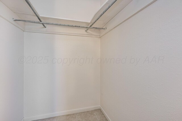 4720 Cherokee Trl, Amarillo, TX 79109 - walk in closet with light tile patterned flooring