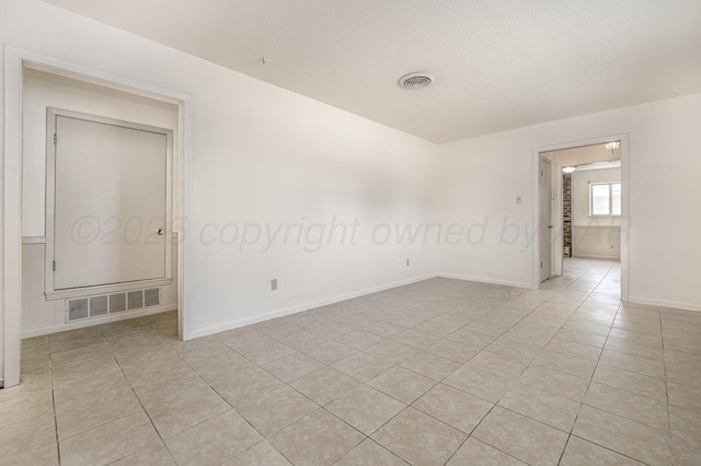 4720 Cherokee Trl, Amarillo, TX 79109 - empty room featuring light tile patterned flooring and a textured ceiling