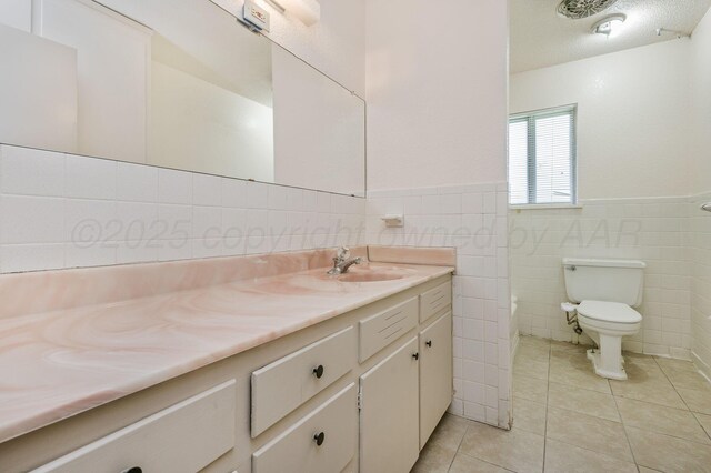 4720 Cherokee Trl, Amarillo, TX 79109 - bathroom with vanity, tile patterned floors, a wainscoted wall, and tile walls