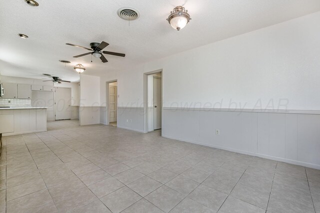 4720 Cherokee Trl, Amarillo, TX 79109 - unfurnished living room featuring a ceiling fan, light tile patterned floors, and a textured ceiling