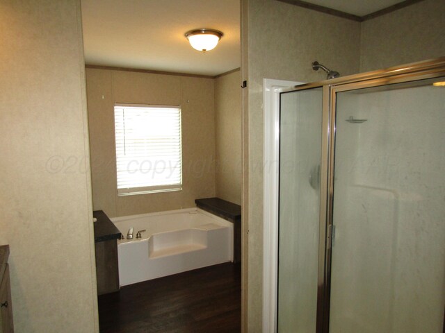 bathroom with independent shower and bath, vanity, wood-type flooring, and crown molding