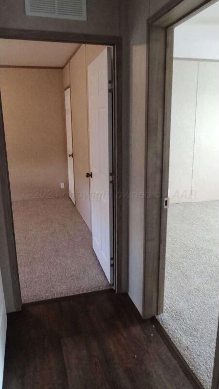 hallway featuring dark hardwood / wood-style flooring