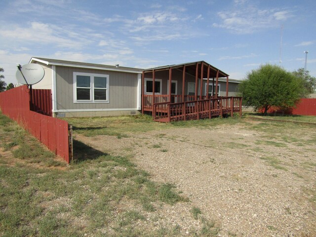 rear view of house featuring a wooden deck