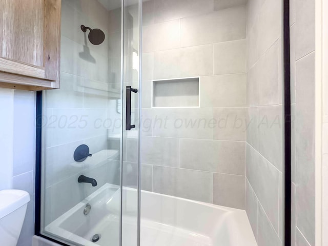 bathroom with toilet and an enclosed shower