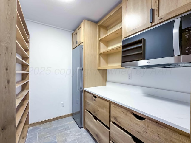 interior space with stone finish flooring and baseboards