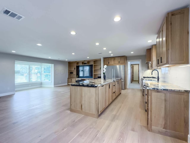 kitchen with light stone counters, recessed lighting, visible vents, light wood-type flooring, and light brown cabinetry