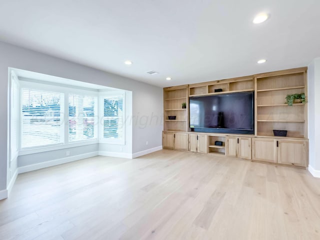 unfurnished living room featuring light wood-style flooring, baseboards, and recessed lighting