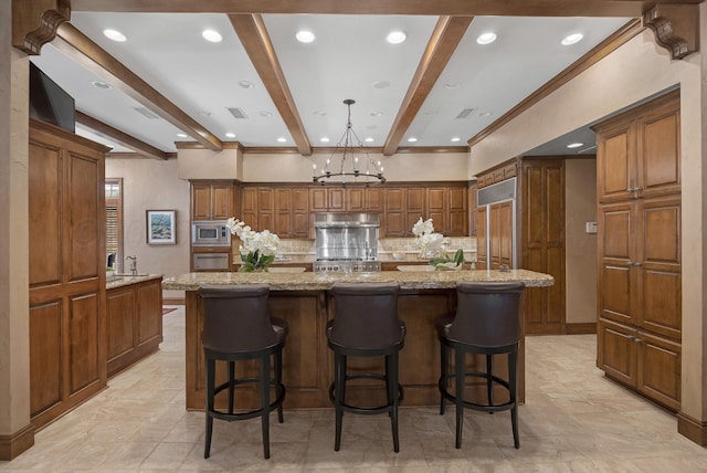 3506 Van Winkle Dr, Amarillo, TX 79121 - kitchen with a spacious island, built in appliances, beamed ceiling, backsplash, and under cabinet range hood