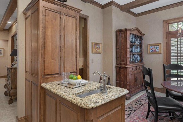 3506 Van Winkle Dr, Amarillo, TX 79121 - interior space with brown cabinetry, baseboards, light stone countertops, and a sink