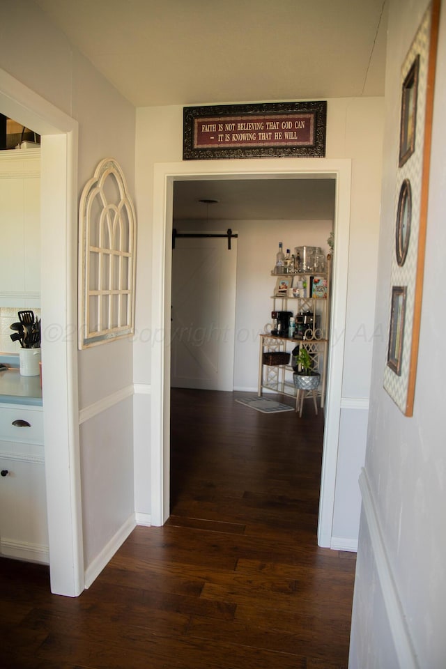 1418 Oak Ave, Panhandle, TX 79068 - hallway with dark wood finished floors and a barn door
