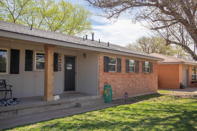 1418 Oak Ave, Panhandle, TX 79068 - view of front of house with brick siding, a front lawn, and a shingled roof