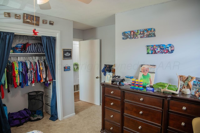 1418 Oak Ave, Panhandle, TX 79068 - bedroom with light colored carpet, a closet, and a ceiling fan