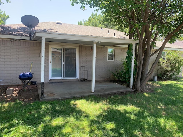 6812 Blacksmith Ln, Amarillo, TX 79109 - rear view of property featuring brick siding, a patio, and a lawn