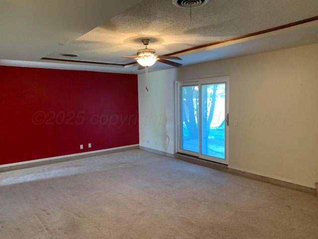 6812 Blacksmith Ln, Amarillo, TX 79109 - unfurnished room with carpet flooring, a textured ceiling, a ceiling fan, and a raised ceiling