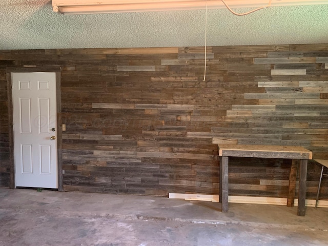 6812 Blacksmith Ln, Amarillo, TX 79109 - interior space featuring wood walls and concrete floors
