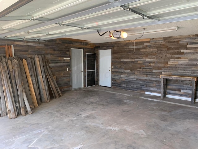 6812 Blacksmith Ln, Amarillo, TX 79109 - garage featuring wood walls and a garage door opener