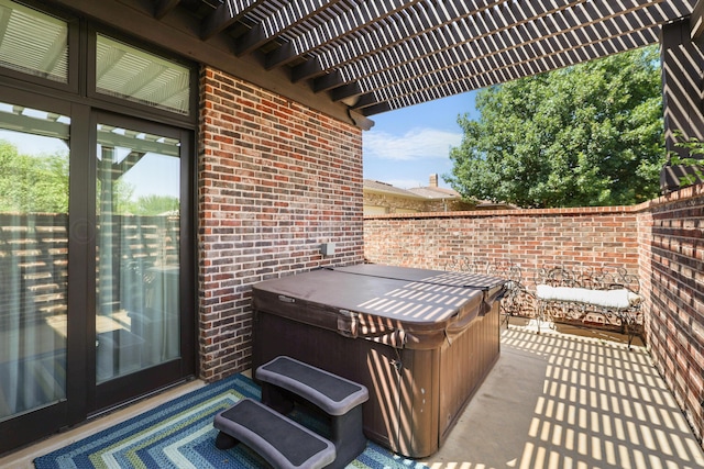 view of patio featuring a hot tub and a pergola