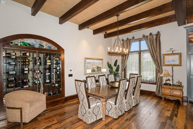 dining space featuring an inviting chandelier, dark hardwood / wood-style flooring, and beamed ceiling